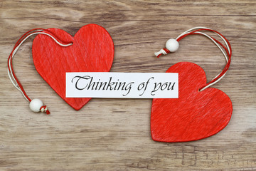 Wall Mural - thinking of you card with two red wooden hearts