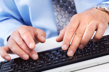 Hands with a computer keyboard.