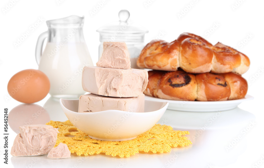 Dry yeast with pastry and baking ingredients isolated on white