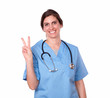 © pablocalvog - Lovely female nurse with victory finger sign