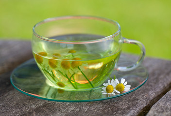 chamomile tea on wooden background