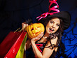 Woman holding Halloween shopping bag.