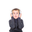 Close up portrait of surprised boy listening to music with headp