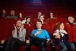 © Nejron Photo - Group of young people watching movie in cinema