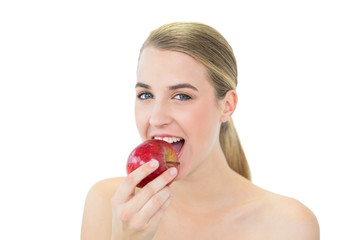 Wall Mural - Attractive blonde eating red apple