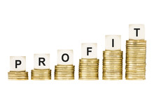 Word PROFIT On Row Of Gold Coin Stacks Isolated White