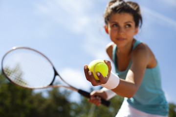 Wall Mural - Girl playing tennis on the court