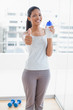 © lightwavemedia - Smiling sporty young woman giving thumbs up