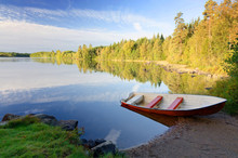 Idyllic September Lake Landscape With Red Rowboat