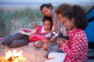 Wall Mural - Family Camping On Beach And Toasting Marshmallows