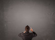 © ra2 studio - Businessman standing in front of an empty wall