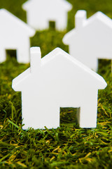 Series Of White Model House Arranged On Grass