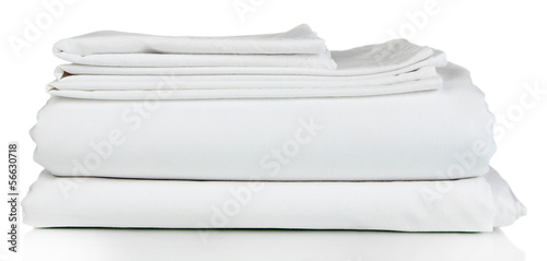 Fotografía Stack of clean bedding sheets isolated on white