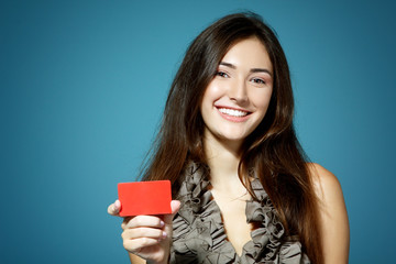 beautiful friendly smiling confident girl showing red card in ha