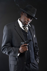 Wall Mural - Retro african american mafia man wearing striped suit and tie an