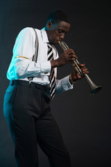 Retro african american jazz musician playing on his trumpet. Wea