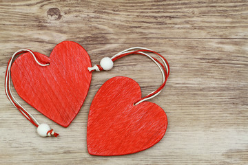 Wall Mural - two red wooden hearts on wooden surface with copy space