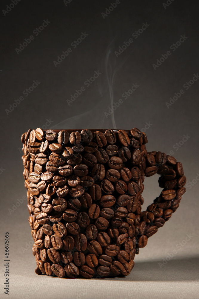 Cup of coffee beans, on grey background