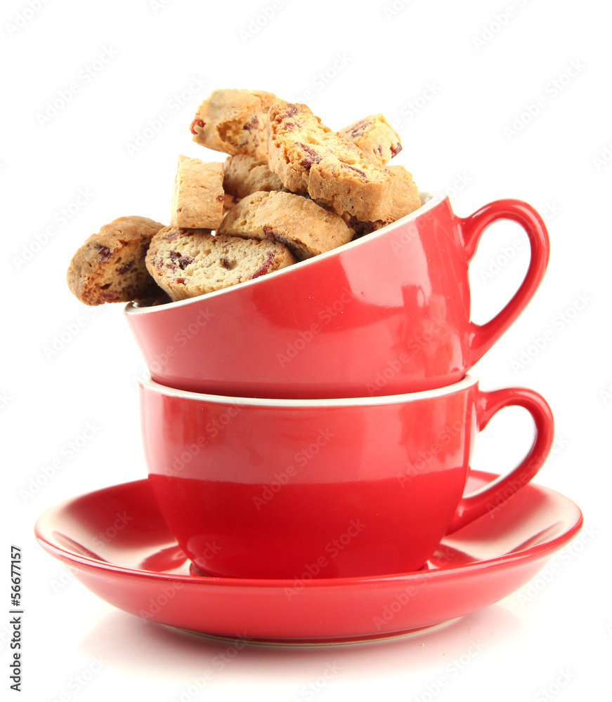 Tasty cookies in cups isolated on white