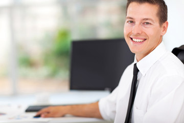 Wall Mural - businessman sitting at office desk