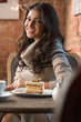 © Milles Studio - Young woman drinking coffee in a cafe