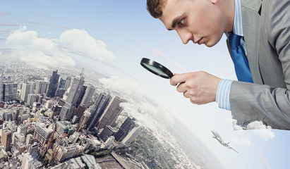 Wall Mural - Man looking in magnifier