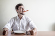 © Eugenio Marongiu - young stylish man with white shirt eating carrot