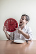 © Eugenio Marongiu - young stylish man with white shirt holding red clock