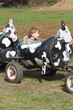 child on a farm ride hayride