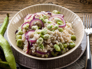 Wall Mural - barley risotto with beans broad and onions, vegetarian food