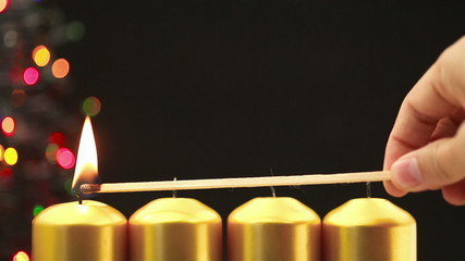Wall Mural - hand lighting four christmas candles for advent