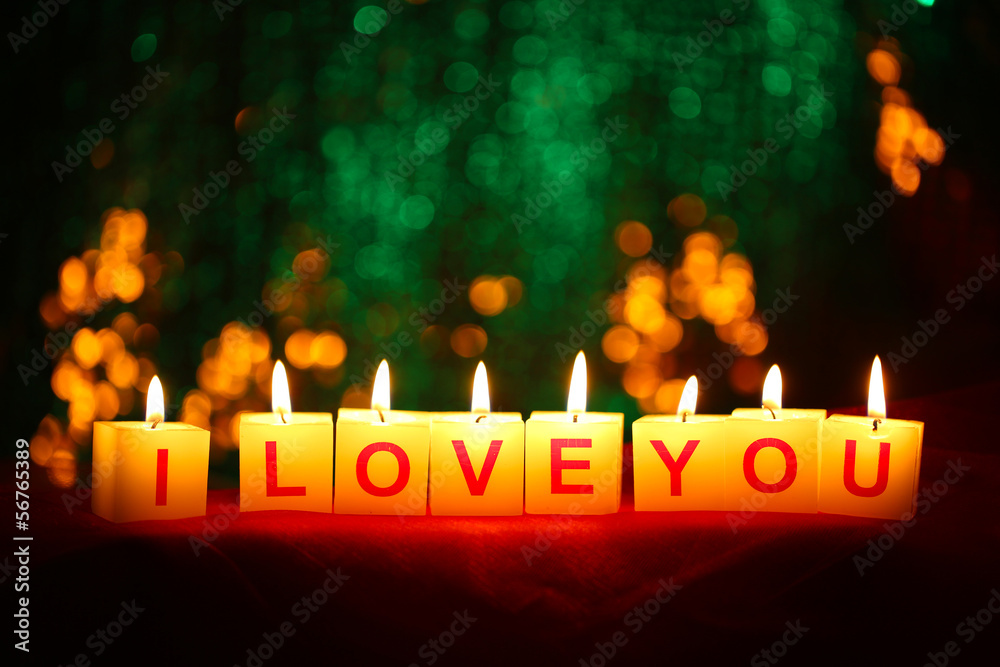 Candles with printed sign I LOVE YOU,on  blur lights background