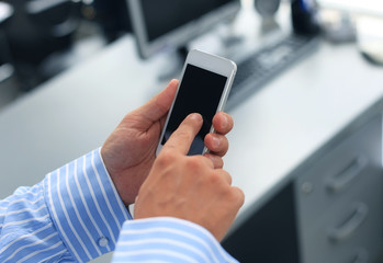 Wall Mural - Close up of a man using mobile smart phone