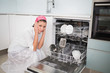 © lightwavemedia - Anxious charming woman sitting next to dish washer