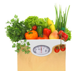 Fresh groceries in a paper bag with weight scale dial