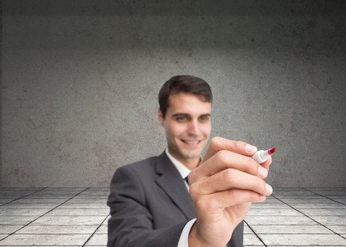 Smiling businessman writing something with marker