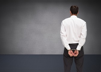 Poster - Rear view of young businessman wearing handcuffs
