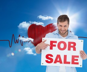 Poster - Smiling model holding a for sale sign