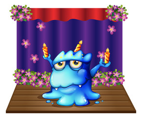 Sticker - A stage with a blue monster balancing the three lighted candles