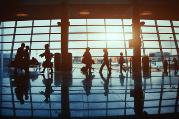 business travel, silhouettes of  people in  airport