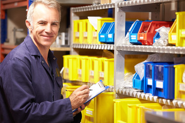 Wall Mural - Worker Checking Stock Levels In Store Room