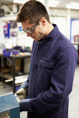 Wall Mural - Apprentice Engineer Working On Factory Floor