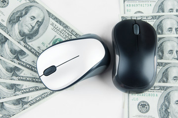 Computer mouses on dollars close up