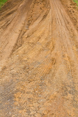 Wall Mural - Background traces wheel vehicles on the road surface clay