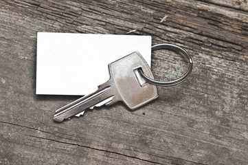 key with a blank label on an old wooden plank