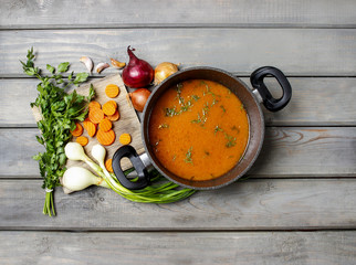 Canvas Print - Top view on pot of tomato soup and fresh vegetables on old woode