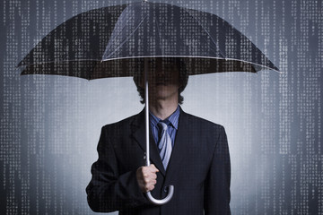 Businessman with an umbrella under digital rain.