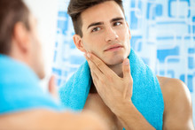 Man Touching His Face After Shaving