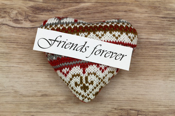 Wall Mural - friends forever card on knitted heart on wooden surface