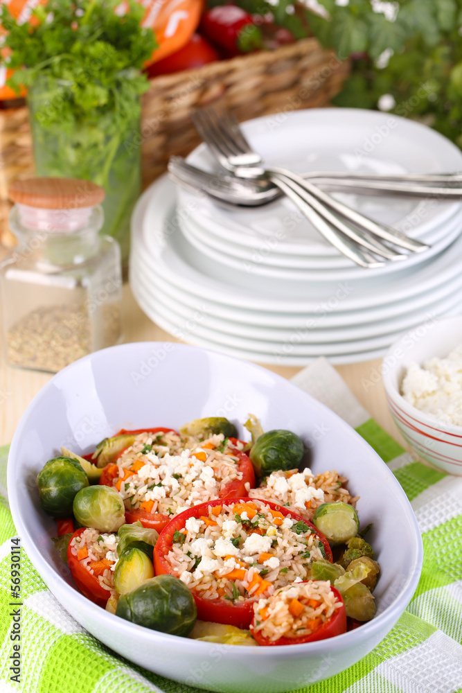 Stuffed tomatoes in bowl on wooden table close-up